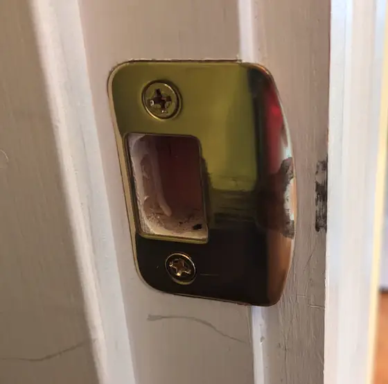 door lock strikeplate on a door jamb