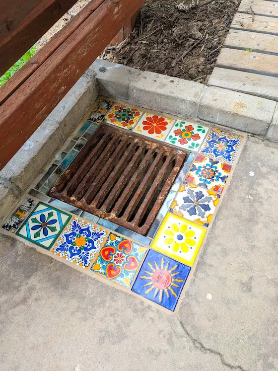 decorative ceramic tile surrounding sewer drain