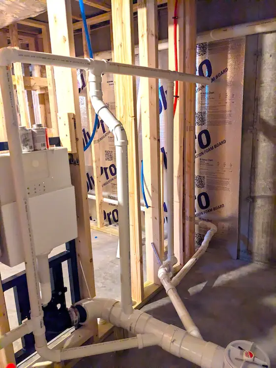 pvc pipes in basement wall hung toiled rough in