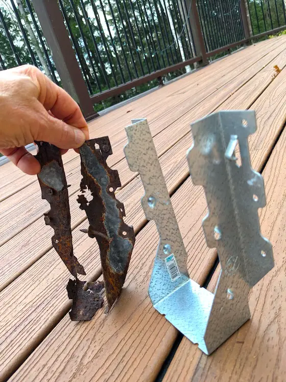 rusted corroded joist hanger next to a new one with zmax coating